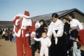 1953년 제주도 어느 마을의 크리스마스 행사장의 산타로 분장한 사람과 아이들.jpg